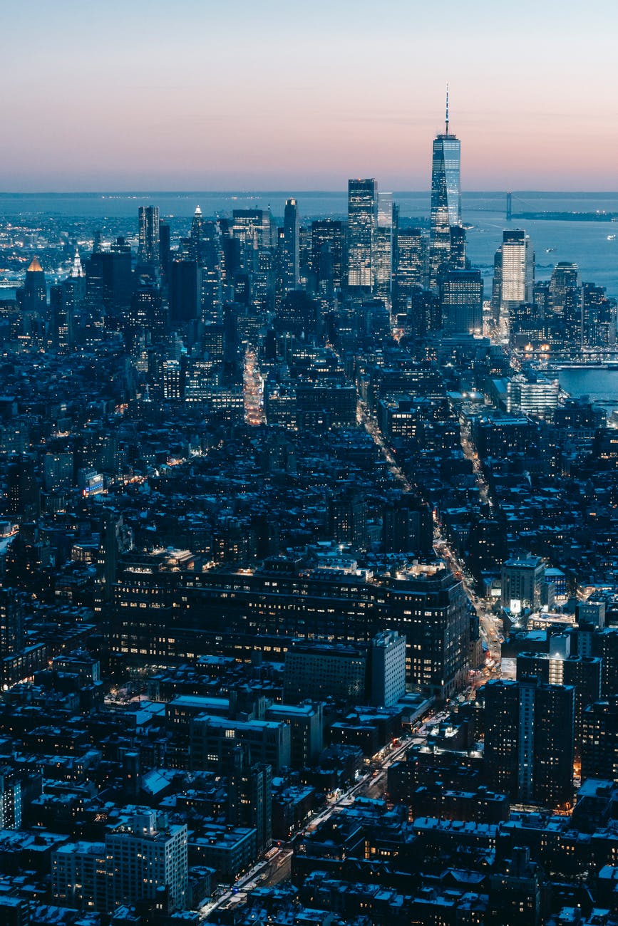 manhattan skyscrapers with glowing lights in dusk