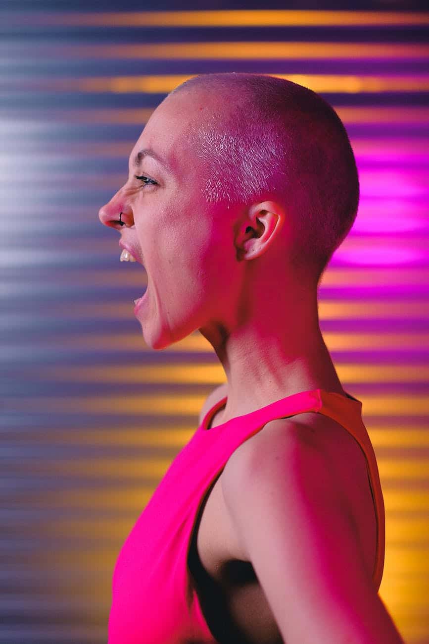 expressive bald woman shouting in studio