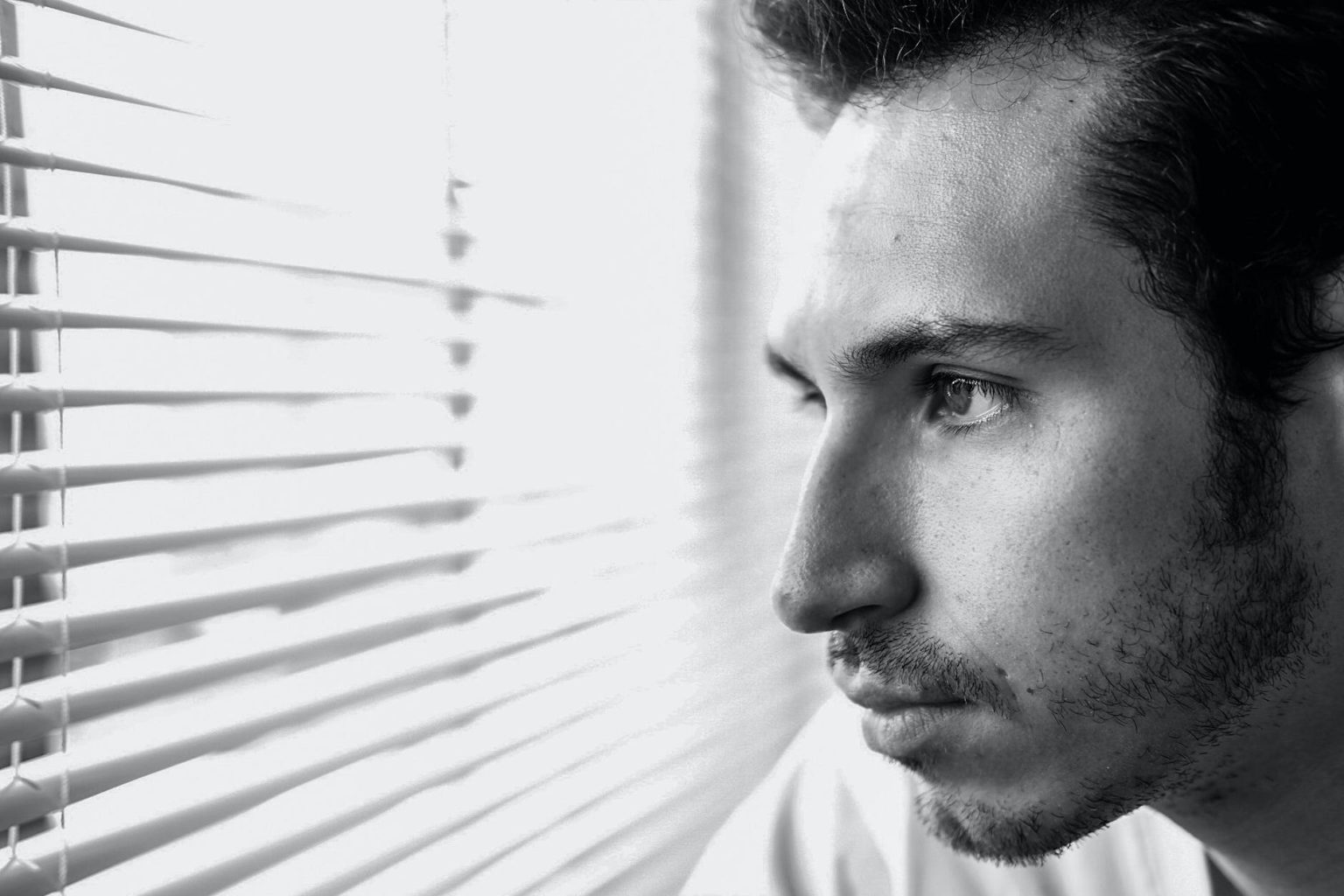 man looking through window